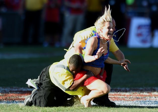 It required two guards to finally bring the woman to the ground.