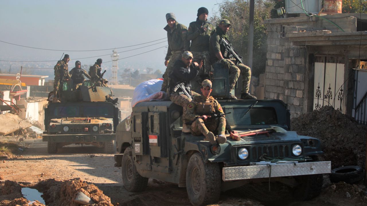 Iraqi security forces taking part in the offensive to retake the western side of Mosul from ISIS  fighters move through the village of al-Buseif on Tuesday.
