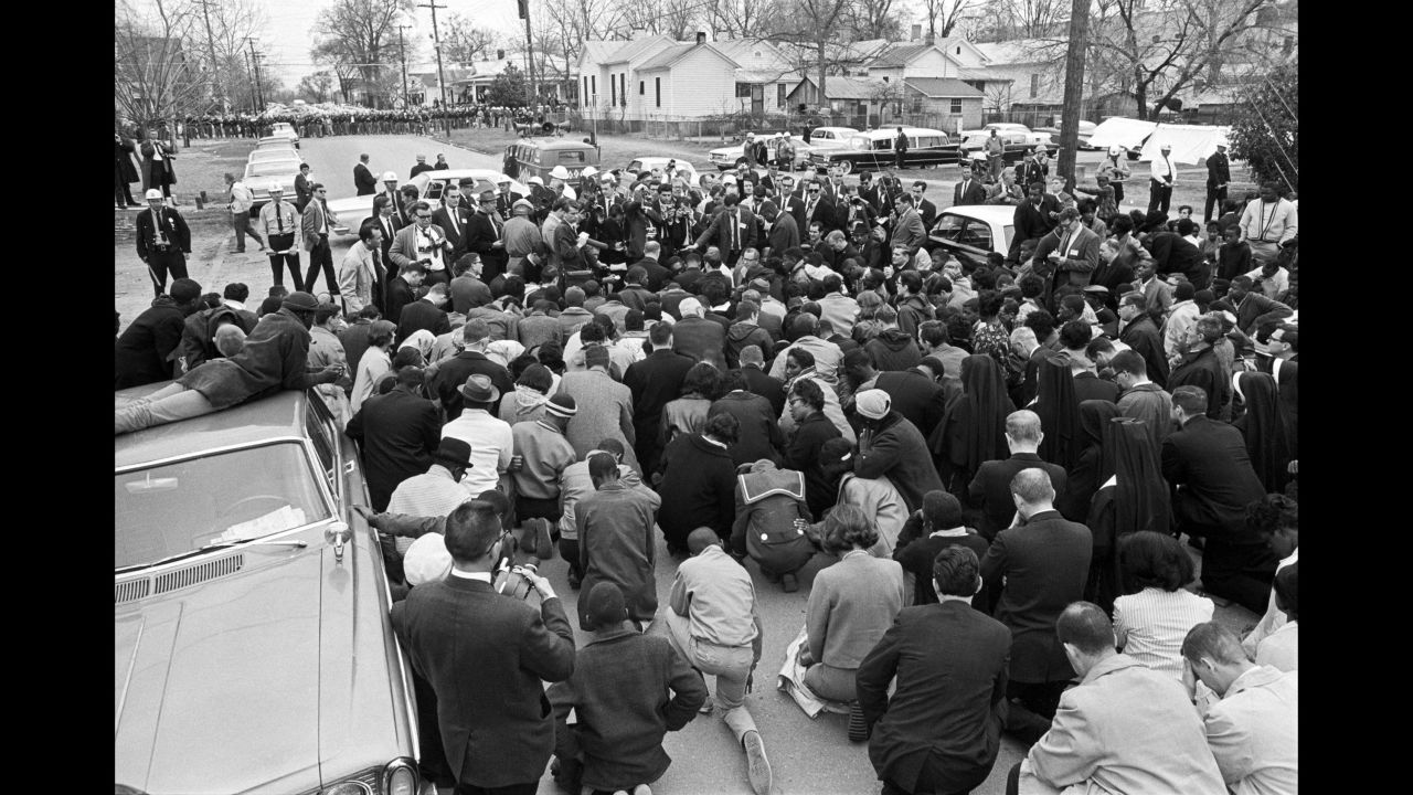 Marchers kneel in prayer after being stopped by state troopers in Selma.