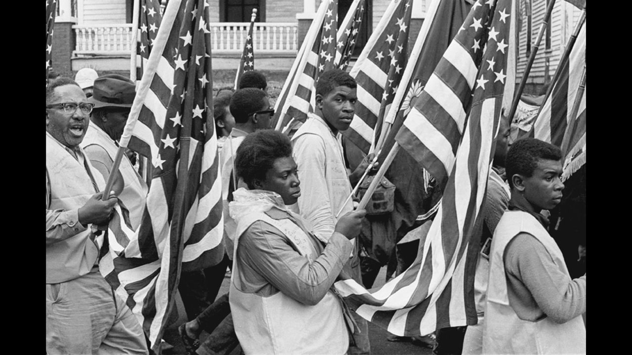 Protesters carry American flags during their march to Montgomery.