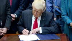 WASHINGTON, DC - FEBRUARY 16:  U.S. President Donald Trump signs H.J. Res. 38, disapproving the rule submitted by the US Department of the Interior known as the Stream Protection Rule in the Roosevelt Room of the White House on February 16, 2017 in Washington, DC.  The Department of Interior's Stream Protection Rule, which was signed during the final month of the Obama administration, "addresses the impacts of surface coal mining operations on surface water, groundwater, and the productivity of mining operation sites," according to the Congress.gov summary of the resolution. (Photo by Ron Sachs-Pool/Getty Images)