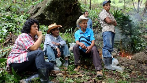 Berta  Cáceres, left, on the banks of the Gualcarque River in western Honduras, where she led the indigenous Lenca people in opposition to the Agua Zarca hydroelectric project. 