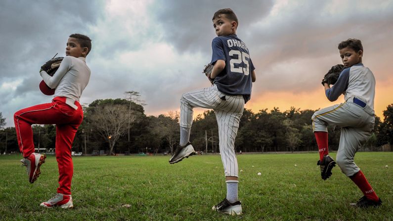 <strong>Havana:</strong> Cuban children limber up during a baseball training session in Havana in February. Baseball is one of the country's most popular sports. <br />