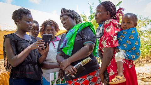 Female farmers learn to use the Mbegu Choice app in Kenya.