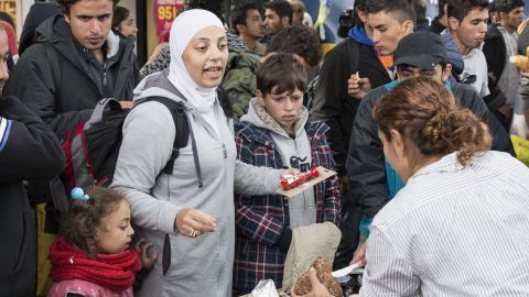 Volunteers hand food and drink to refugees arriving at Malmo station in Sweden in September 2015.