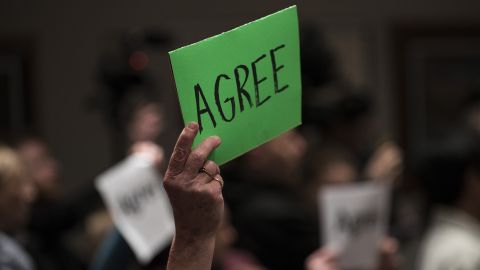 A constituent holds up sign which reads "Agree" during a town hall meeting with Rep Tom Emmer (R-MN) on February 22, 2017 in Sartell, Minnesota.