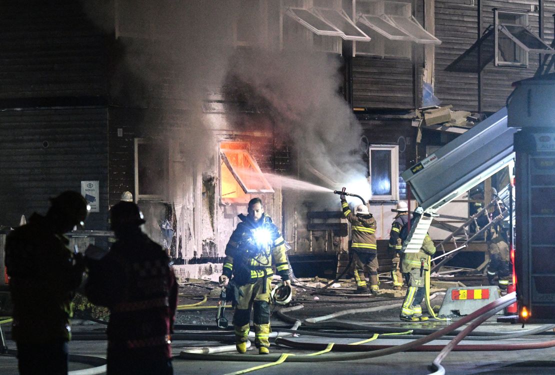 Firefighters tackle a suspected arson attack at a refugee accommodation block in Fagersjo, south of Stockholm, in October 2016.  