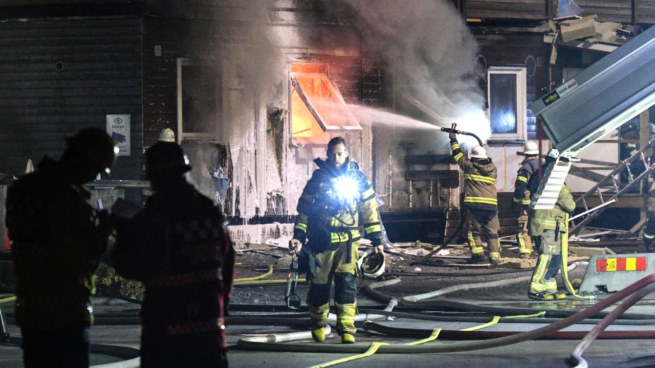 Firefighters tackle a suspected arson attack at a home for refugees in Fagersjo in October 2016.  