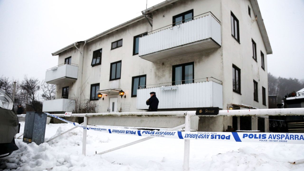An officer guard the home for asylum seekers where a worker was stabbed to death in 2016.