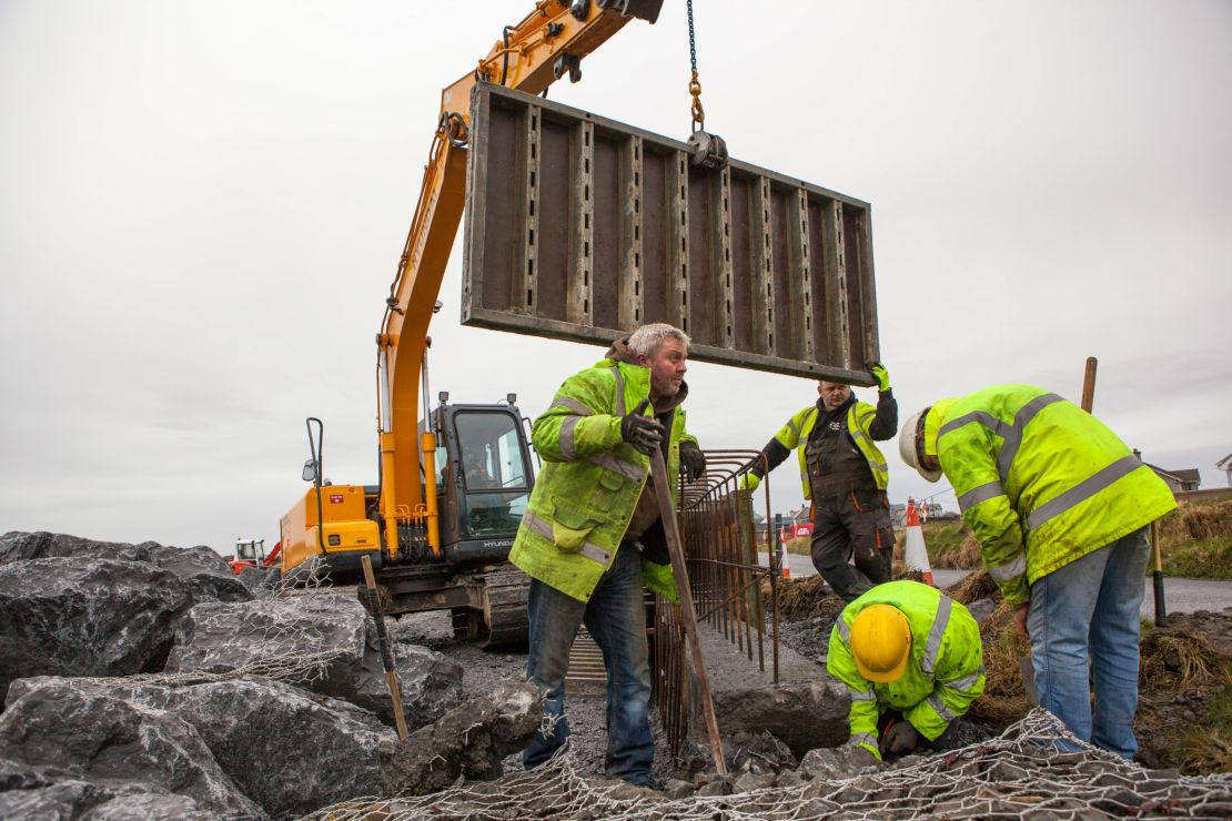 Workers construct a "rock-armor" erosion wall in a residential area of Doonbeg. They say these type of walls are commonplace in Ireland and believe Trump's proposed wall would also stop sea water from entering flood prone areas in Doonbeg. But this residential wall, above, is not being built on protected sand dunes -- which is the primary concern of environmentalists opposed to Trump's wall.