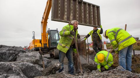 Workers construct a "rock-armor" erosion wall in a residential area of Doonbeg. They say these type of walls are commonplace in Ireland and believe Trump's proposed wall would also stop sea water from entering flood prone areas in Doonbeg. But this residential wall, above, is not being built on protected sand dunes -- which is the primary concern of environmentalists opposed to Trump's wall.