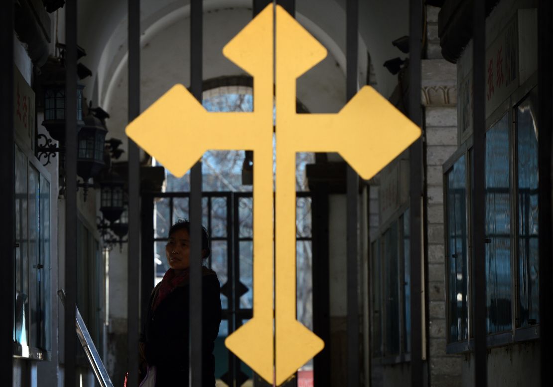 A Chinese Catholic arrives to attend a church service at the East Cathedral in Beijing on February 19, 2013.