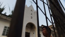 This photo taken on May 11, 2016 shows a villager outside the Catholic church in Changjing, in China's southern Guangxi region.
