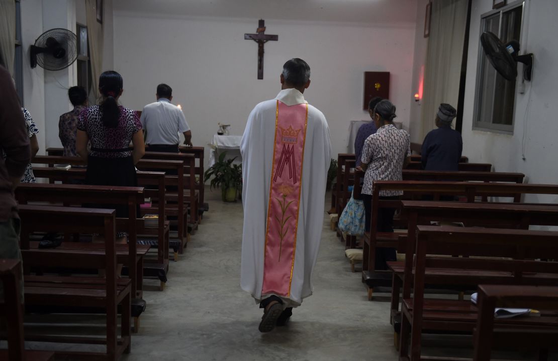 This photo taken on May 11, 2016 shows a priest about to start a mass at the Catholic church in Dingan, in China's southern Guangxi region.