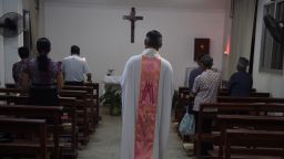 This photo taken on May 11, 2016 shows a priest about to start a mass at the Catholic church in Dingan, in China's southern Guangxi region.
The finishing touches are being put to a new museum in Dingan, the village where French missionary Auguste Chapdelaine died in 1856, celebrating the patriotism of his execution and condemning the spiritual opium of religion. / AFP / GREG BAKER / TO GO WITH China-culture-religion-Roman-Catholic-politics,FEATURE by Benjamin Carlson        (Photo credit should read GREG BAKER/AFP/Getty Images)
