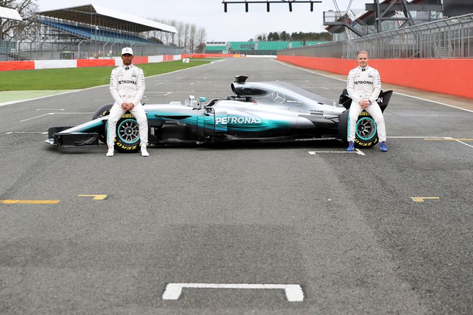 Lewis Hamilton and Valtteri Bottas pose with the Mercedes W08 -- the car the dominant German team hopes will fuel further success in Formula One.  