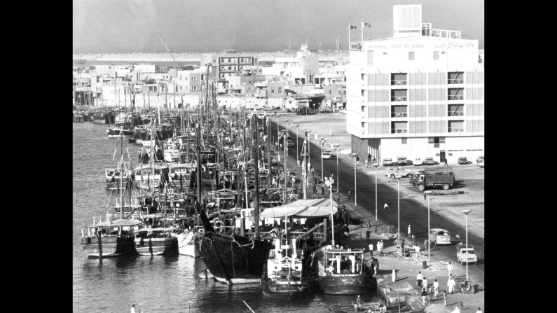 In 1971, Dubai became a founding member of the United Arab Emirates. Pictured, Dubai Creek crowded with dhows. On the right is the National Bank of Dubai. 