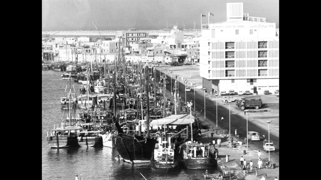 In 1971, Dubai became a founding member of the United Arab Emirates. Pictured, Dubai Creek crowded with dhows. On the right is the National Bank of Dubai. 