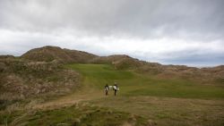 doonbeg surfers walk through greens