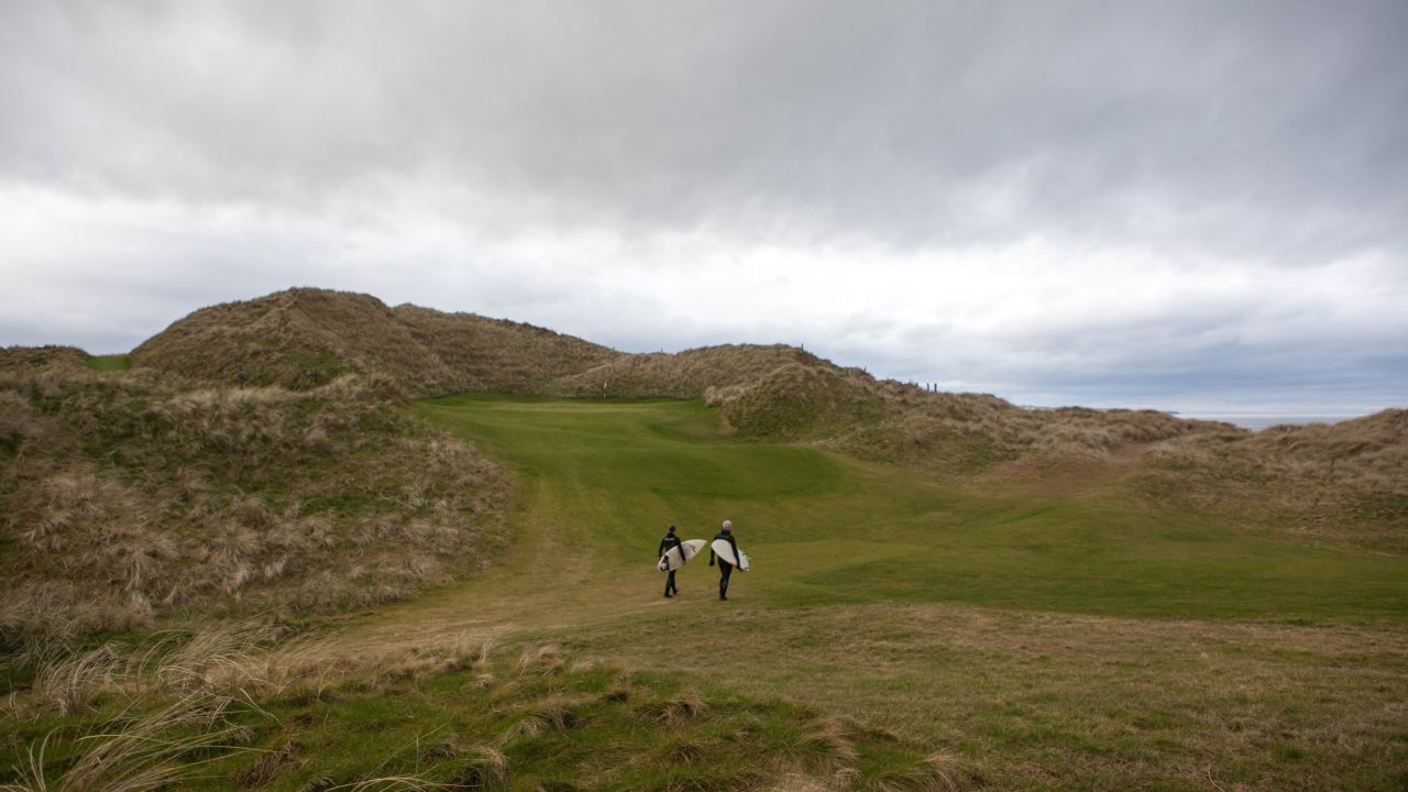 doonbeg surfers walk through greens