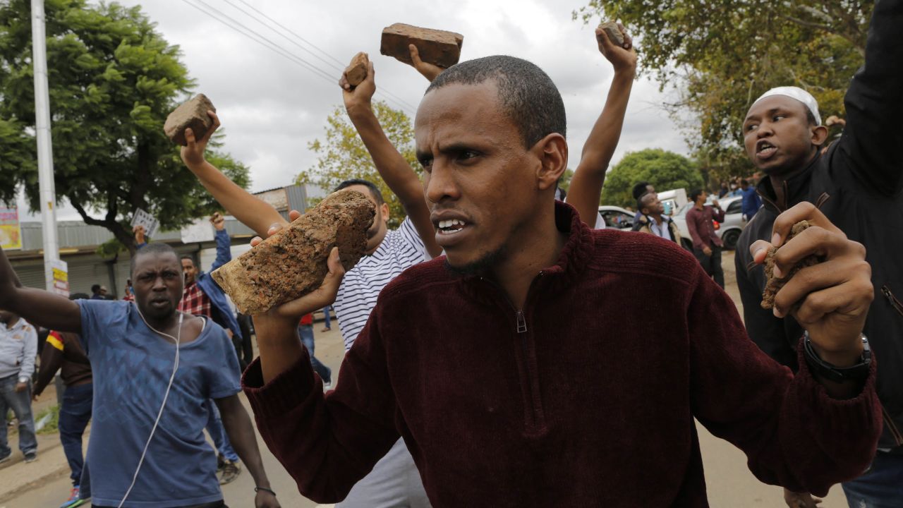 epa05812018 Foreign residents gesture at local South African's during a xenophobic march by the Mamelodi Concerned Residents through the streets of Pretoria, South Africa, 24 February 2017. Local South African residents have been attacking foreign owned shops in the city this week looting goods.  EPA/KIM LUDBROOK