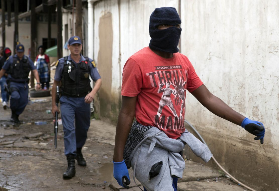 Police follow a South African protester in  the latest wave of anti-immigrant protests to break out in the capital. 