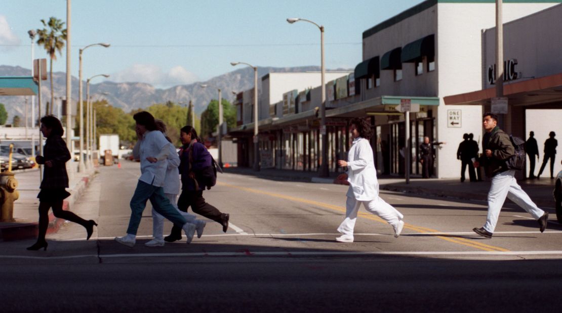 People rush across Bellingham Avenue in North Hollywood to get away from the Bank of America. 