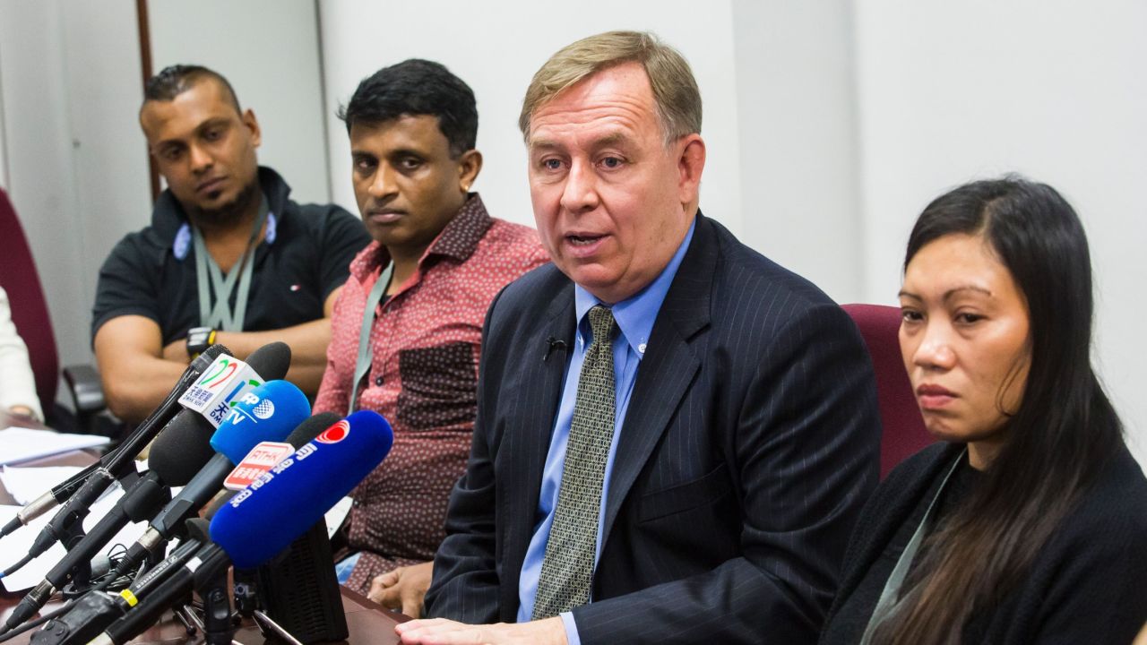 Sri Lankan refugee Supun Thilina Kellapatha (L), 32, Sri Lankan refugee Ajith Puspa (2nd L), 45, and Filipino refugee Vanessa Rodel (R), 40, look on as their lawyer Robert Tibbo (2nd R) speakes at a press conference at the Legislative Council of Hong Kong on February 23, 2017.