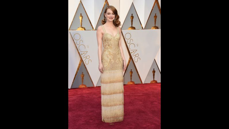 Emma Stone walks the red carpet before the Academy Awards on Sunday, February 26.