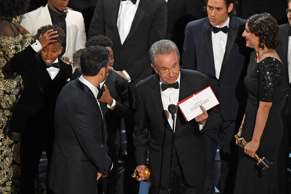 The cast of "Moonlight" and "La La Land" appear on stage as presenter Warren Beatty shows the winner's envelope for Best Movie "Moonlight" on stage.