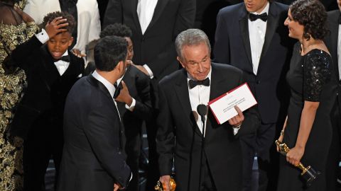 The cast of "Moonlight" and "La La Land" appear on stage as presenter Warren Beatty shows the winner's envelope for Best Movie "Moonlight" on stage.