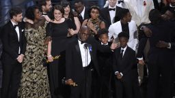 Barry Jenkins, foreground center, and the cast accept the award for best picture for "Moonlight" at the Oscars on Sunday, Feb. 26, 2017, at the Dolby Theatre in Los Angeles. (Photo by Chris Pizzello/Invision/AP)