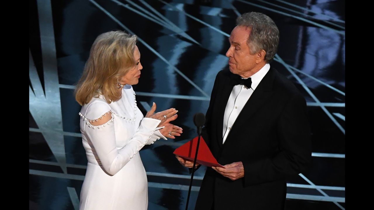 Actors Faye Dunaway (left) and Warren Beatty present on stage the Best Film award at the 89th Oscars on February 26, 2017 in Hollywood, California. 