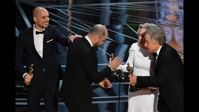 "La La Land" producer Jordan Horowitz, center, accepts the award for best picture next to producer Fred Berger.