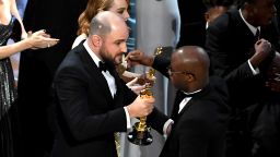HOLLYWOOD, CA - FEBRUARY 26:  ''La La Land' producer Jordan Horowitz (L) hands over the Best Picture award to 'Moonlight' writer/director Barry Jenkins following a presentation error onstage during the 89th Annual Academy Awards at Hollywood & Highland Center on February 26, 2017 in Hollywood, California.  (Photo by Kevin Winter/Getty Images)