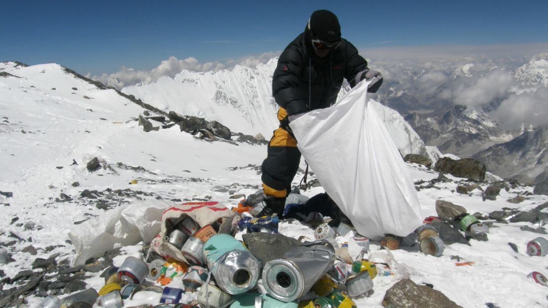 A Sherpa collects refuse on Everest. One third of people who have died on Everest have been Sherpas.
