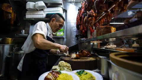 Chan Hong Meng prepares meals at his Hong Kong Chicken Rice and Noodle stall at Chinatown Complex on July 24, 2016 in Singapore. Chan was awarded a one-star rating by Michelin on July 21, making him one of the first street food hawkers to be awarded in the guide's history.