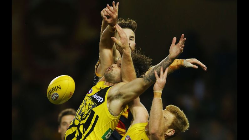 Players collide during an Australian Football League match between the Richmond Tigers and the Adelaide Crows on Friday, February 24.