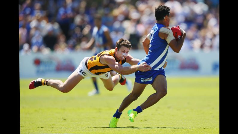 Hawthorn's Liam Shiels tackles North Melbourne's Lindsay Thomas during an Australian Football League match on Sunday, February 26.