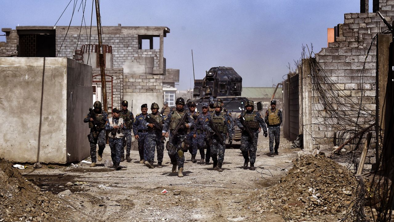 Members of the Iraqi federal police patrol Mosul during an operation to retake the city from ISIS.