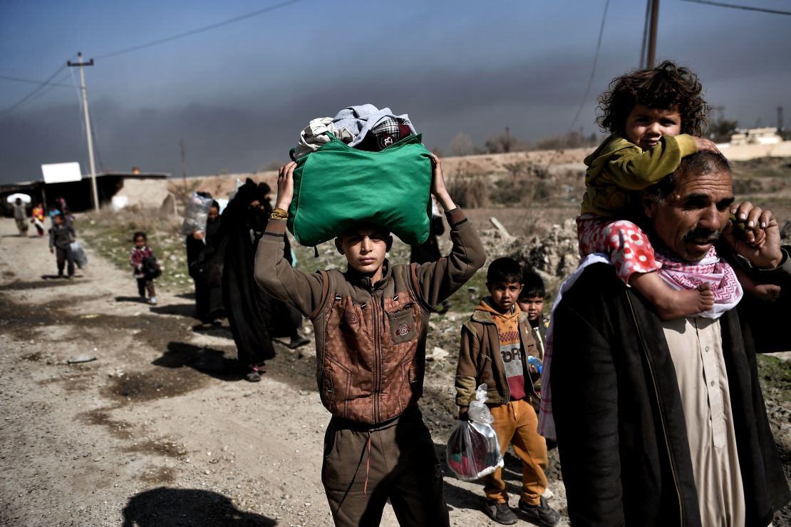 Displaced Iraqis flee the city of Mosul during an operation to retake the city from ISIS.