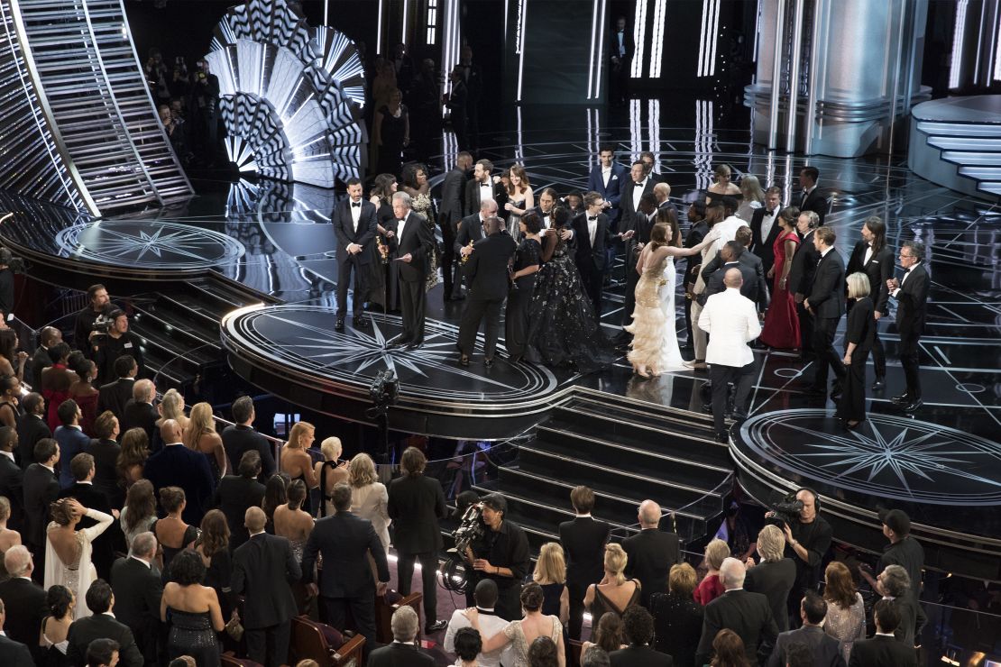 The scene at the Oscars after "La La Land" was mistakenly announced as the best picture winner instead of "Moonlight." On stage, the casts trade places as presenter Warren Beatty explains the snafu. In the crowd, Chrissy Teigen can be seen with her hands on her head in shock. 