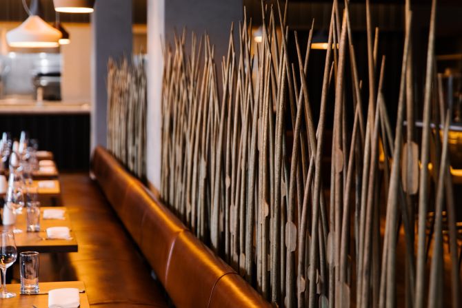 The attached CO-OP restaurant and lounge is delicately divided by a locally sourced sculptural element. This wispy, reed-like partition was created by a Philadelphia blacksmith.