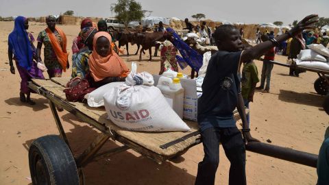 Displaced people fleeing from Boko Haram incursions into Niger attend a World Food Programme (WFP) and USAID food distribution at the Asanga refugee camp near Diffa on June 16, 2016.