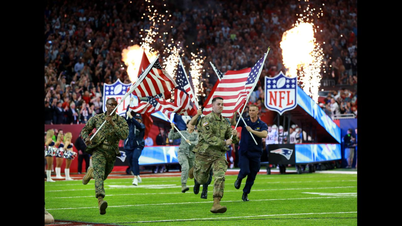 Members of the US military run with American flags before the start of <a href="http://www.cnn.com/2017/02/05/sport/gallery/super-bowl-li/index.html" target="_blank">Super Bowl LI </a>on Sunday, February 5.