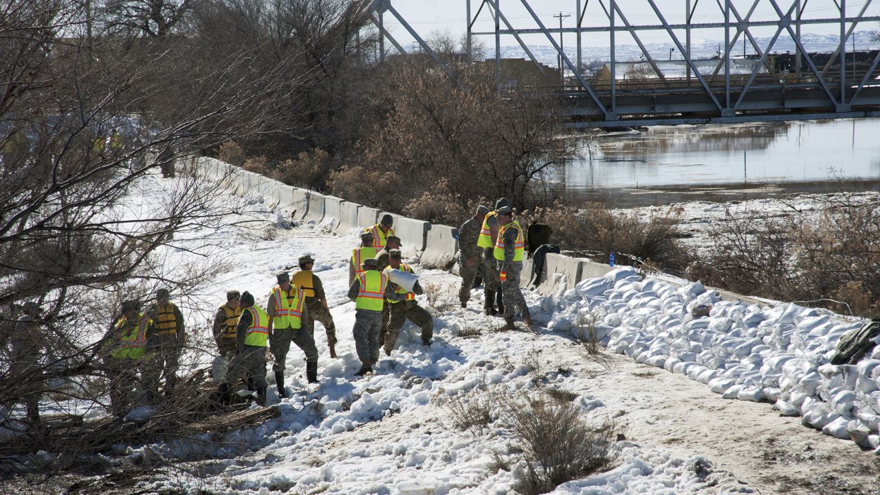 Members of the Wyoming Army National Guard help reinforce a dike along the Big Horn River in Worland, Wyoming, on Monday, February 13. Troops, firefighters and local residents stacked sandbags along the river after it jumped its banks and forced the evacuation of more than 100 homes and businesses.