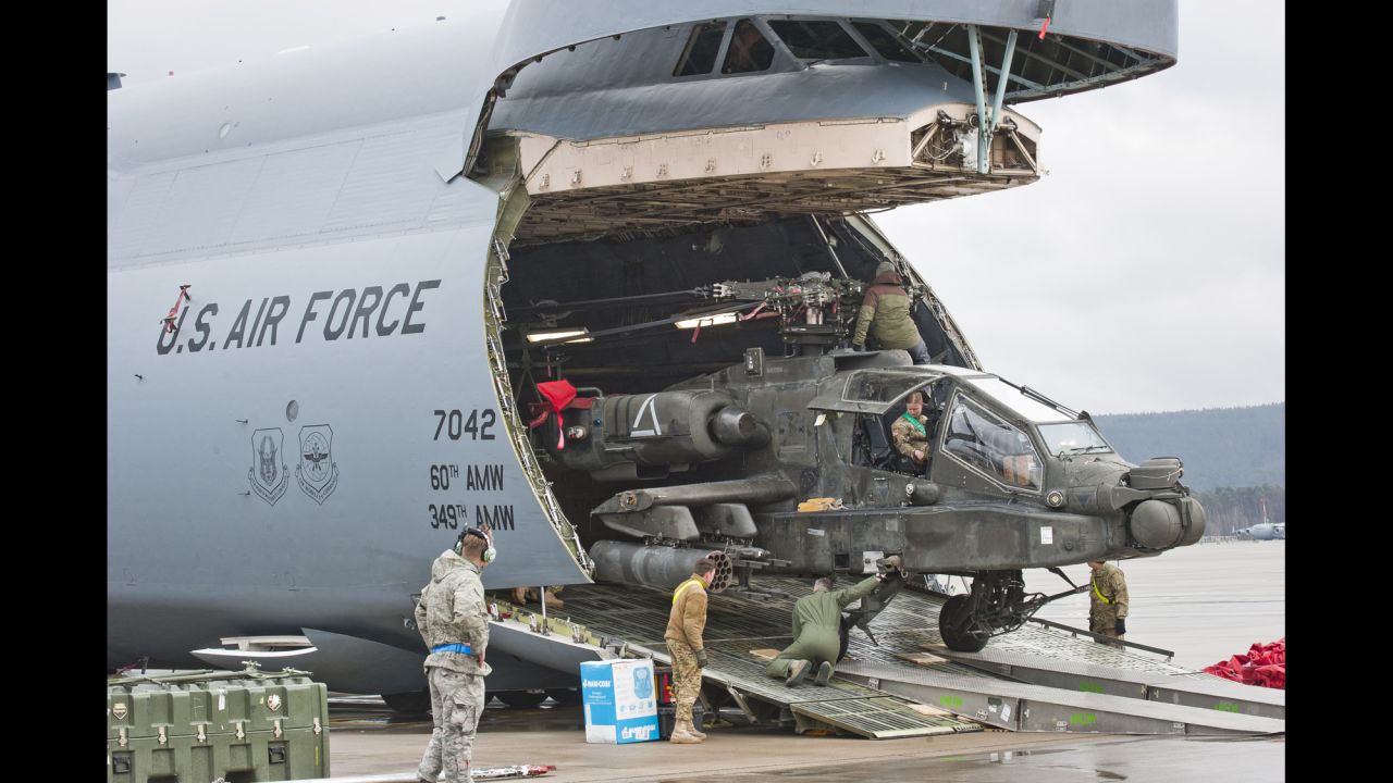 A helicopter is unloaded from a transport plane at Ramstein Air Base, a US Air Force facility in western Germany, on Wednesday, February 22.