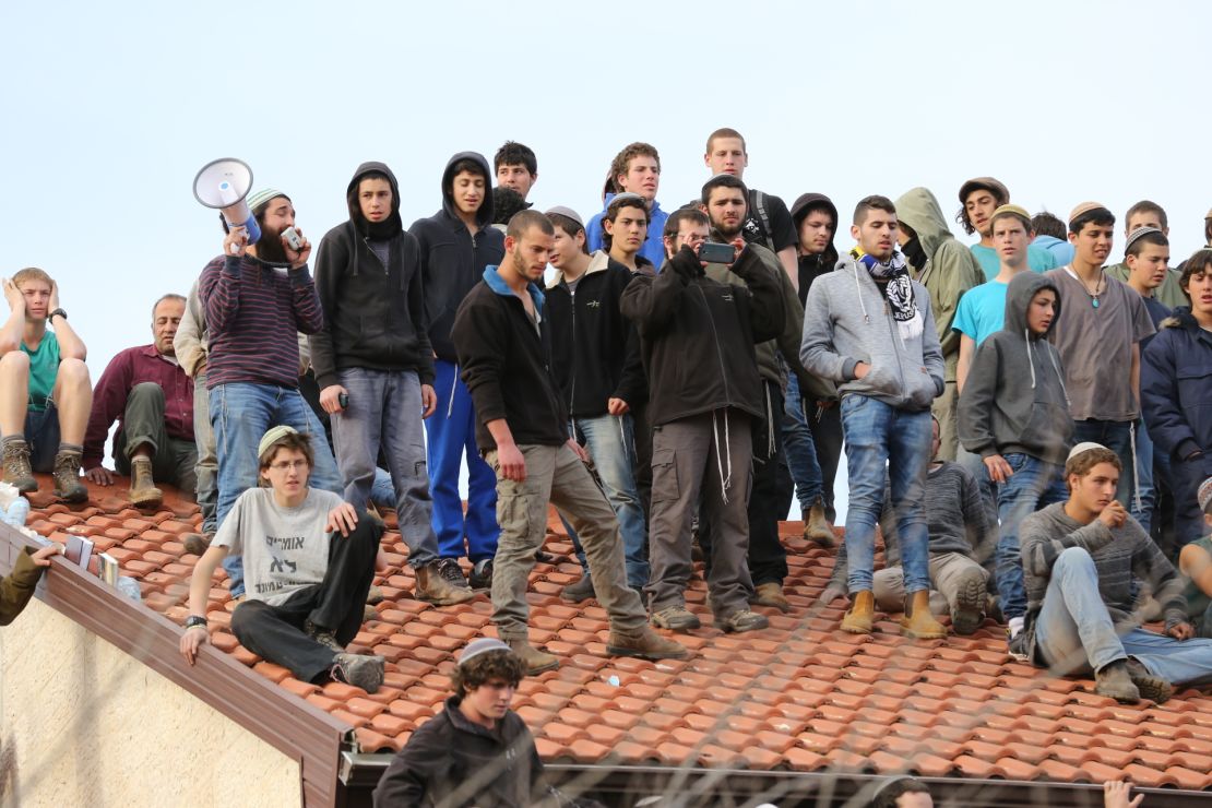 Protesters atop the roof of one of the nine houses.