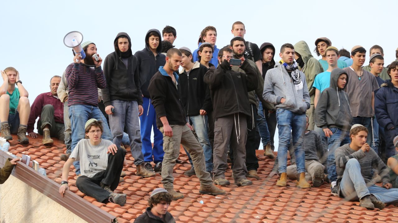 Protesters atop the roof of one of the nine houses.