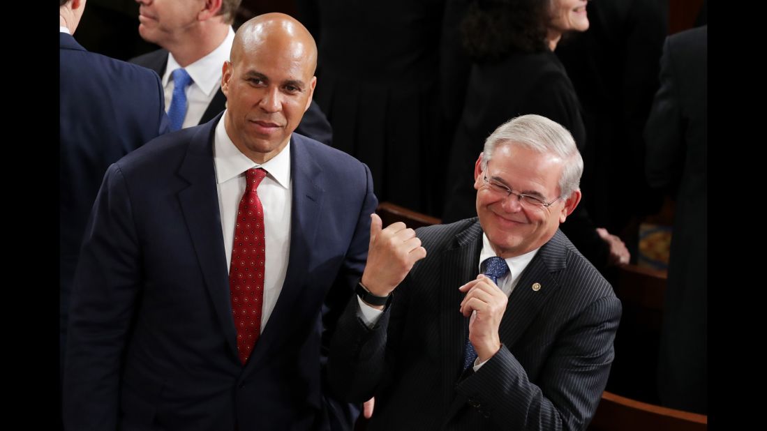 US Sens. Cory Booker and Bob Menendez arrive in the House chamber.